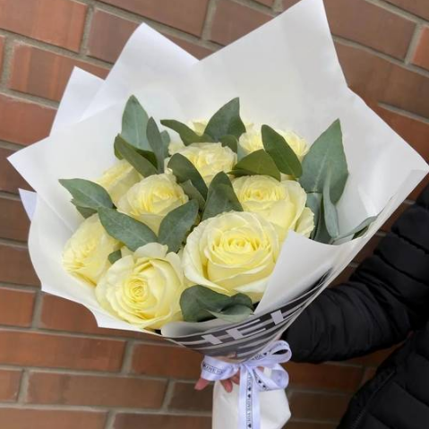 10 White Roses with eucalyptus in a craft paper